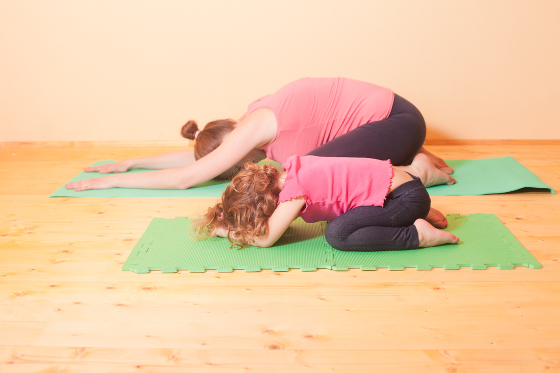 Mother and Daughter Doing Yoga Exercises